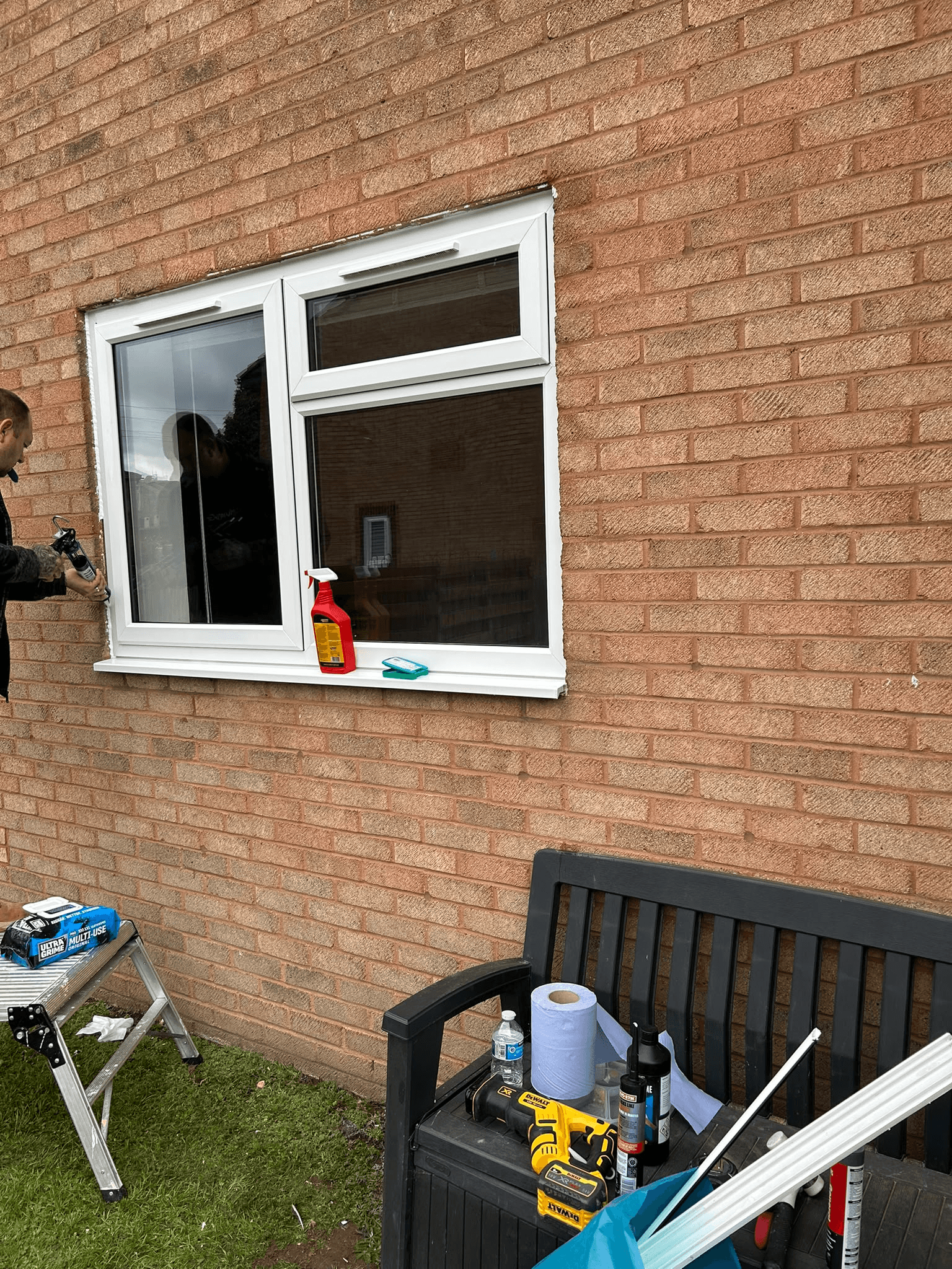 uPVC window being fitted on brick exterior